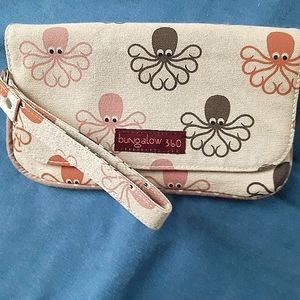 bungalow 360 clutch wristlet with strap. Colors: tan, brown pink, orange